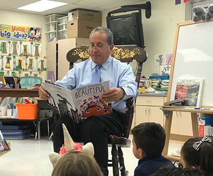 Mayor_Stermer reading book in rocking chair