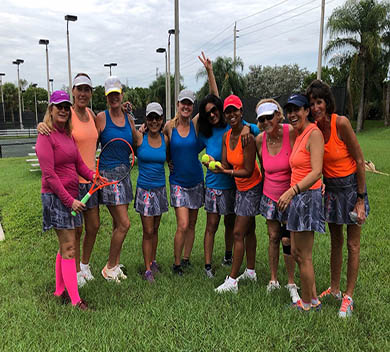 10 Women from the Weston Tennis Center Women's Tennis League posing for photo in front of courts