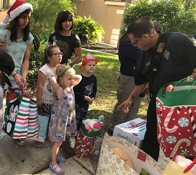 Firefighters handing out gifts to the Barnes family in Weston FL