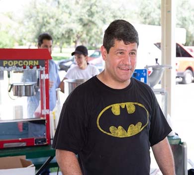 Deputy Martinez in Batman t-shirt next to popcorn machine