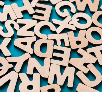 Scattered wooden block letters on blue surface