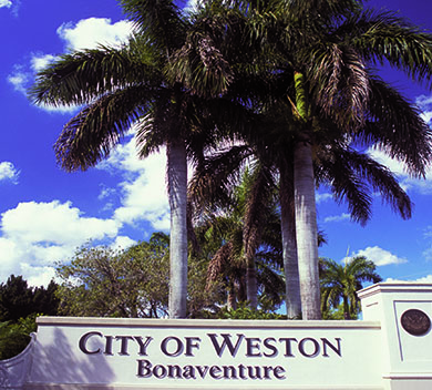 City of Weston Bonaventure monument sigh with two palm trees behind it