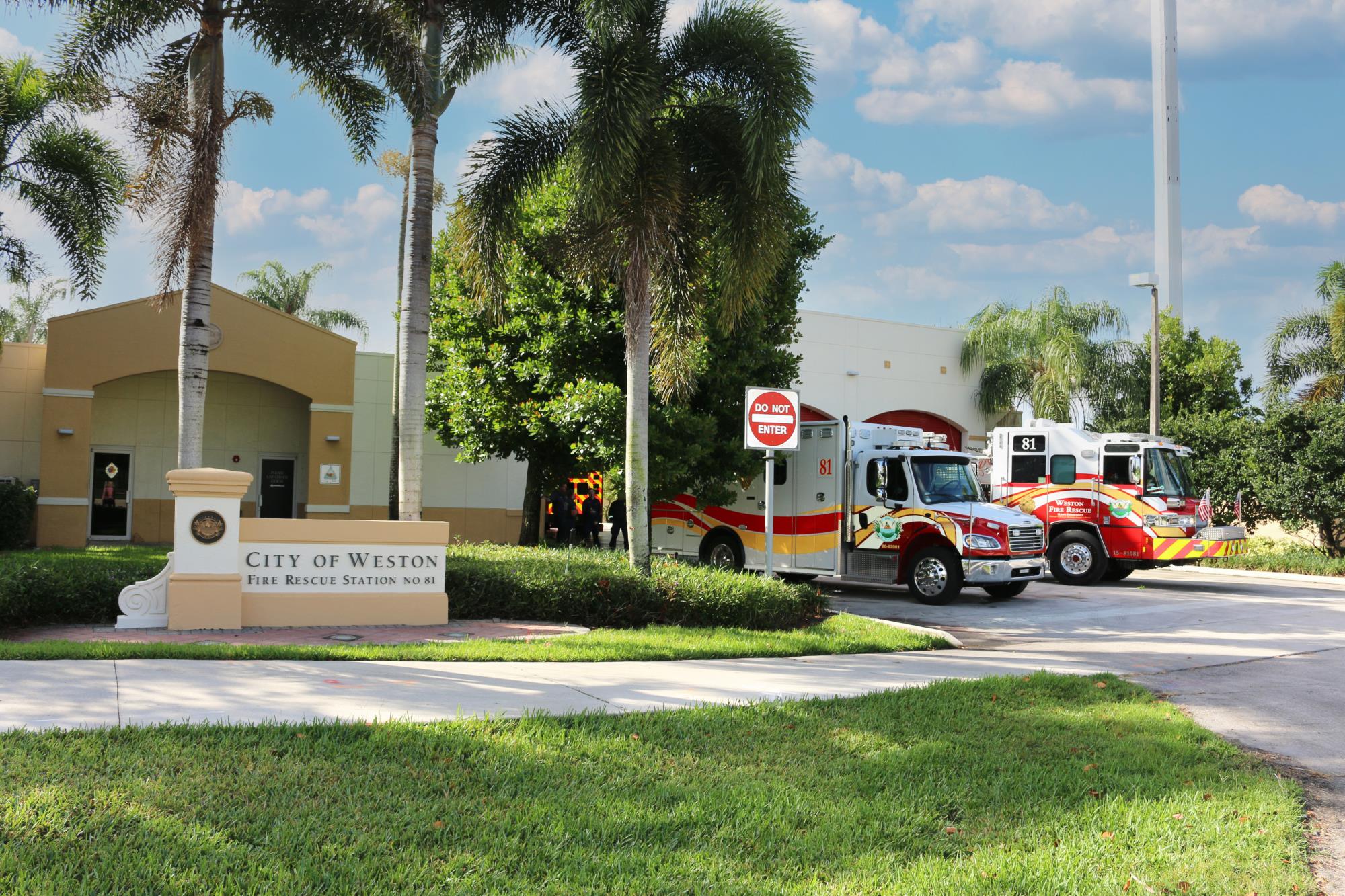 Fire Station 81 on a sunny day with two fire rescue vehicles in front of the garage.