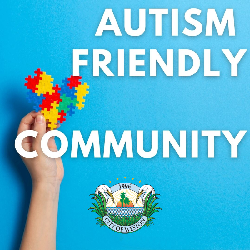 Autism Friendly Community with child's hand holding a heart made of multi-colored puzzle pieces