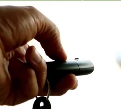 Hand squeezing car key fob