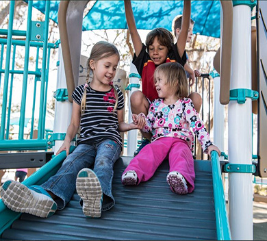 three kids on a playground