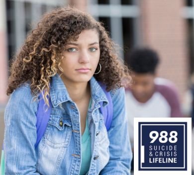 Teen with brown wavy hair in jean jacket